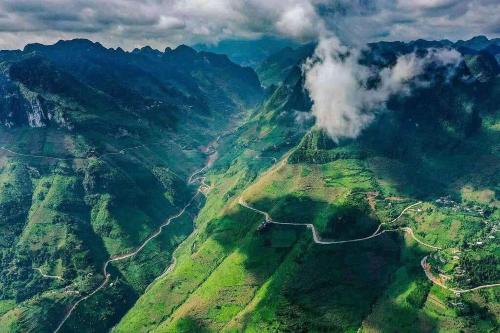 Majestic view of Ma Pi Leng Pass with winding roads carved into the mountains and deep valleys below