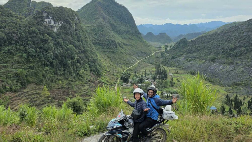 Hmong guide and tourist riding a motorbike during the 2-day Ha Giang Motorbike Tour