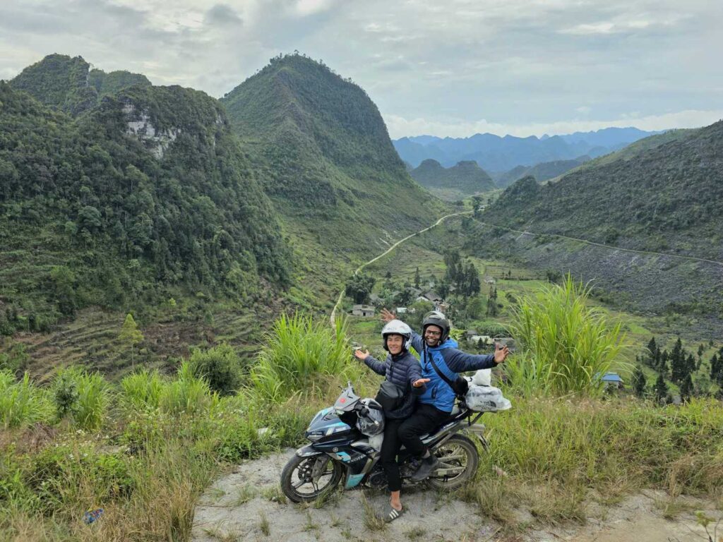 Hmong guide and tourist riding a motorbike during the 2-day Ha Giang Motorbike Tour