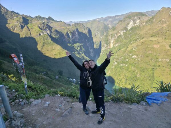 Couple enjoying the view at Ma Pi Leng Pass, Ha Giang
